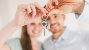 Happy Couple Holding and Showing a House Key