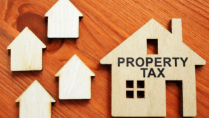 Wooden house figures representing property tax