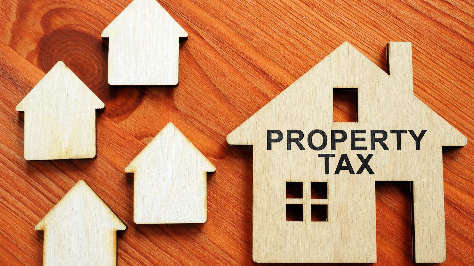 Wooden house figures representing property tax